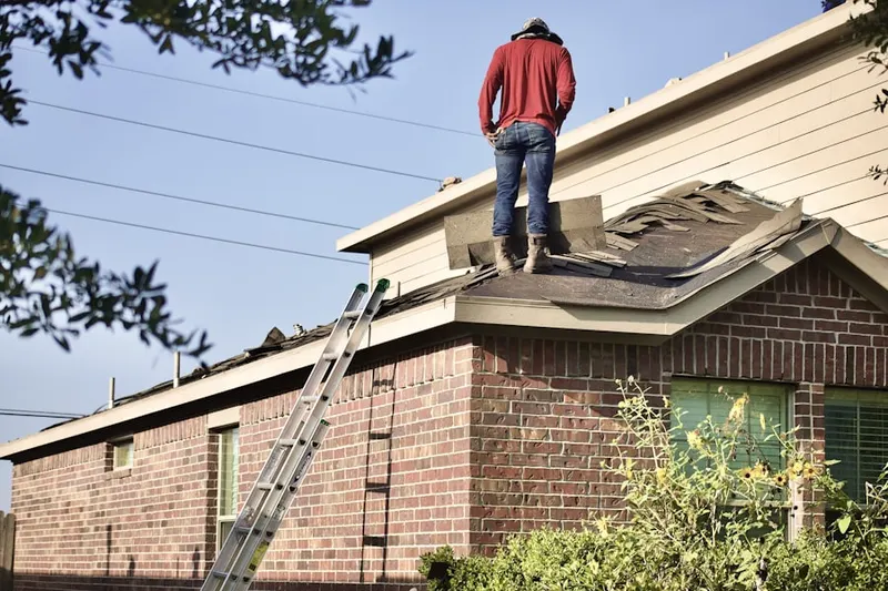 Professional roofer working on a residential roof in Milford Square